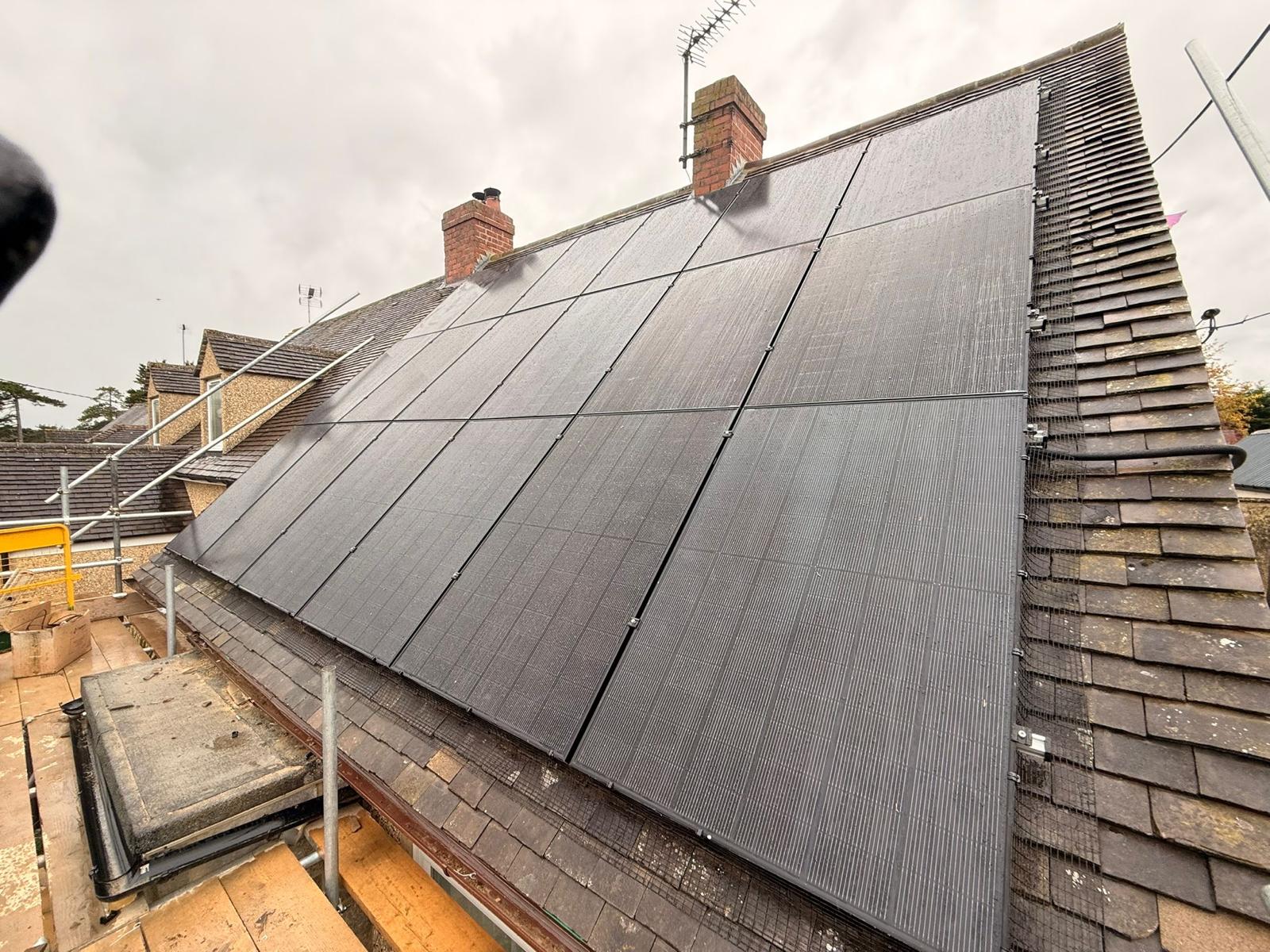 Solar panels with bird protection wire mesh on a wet tiled roof